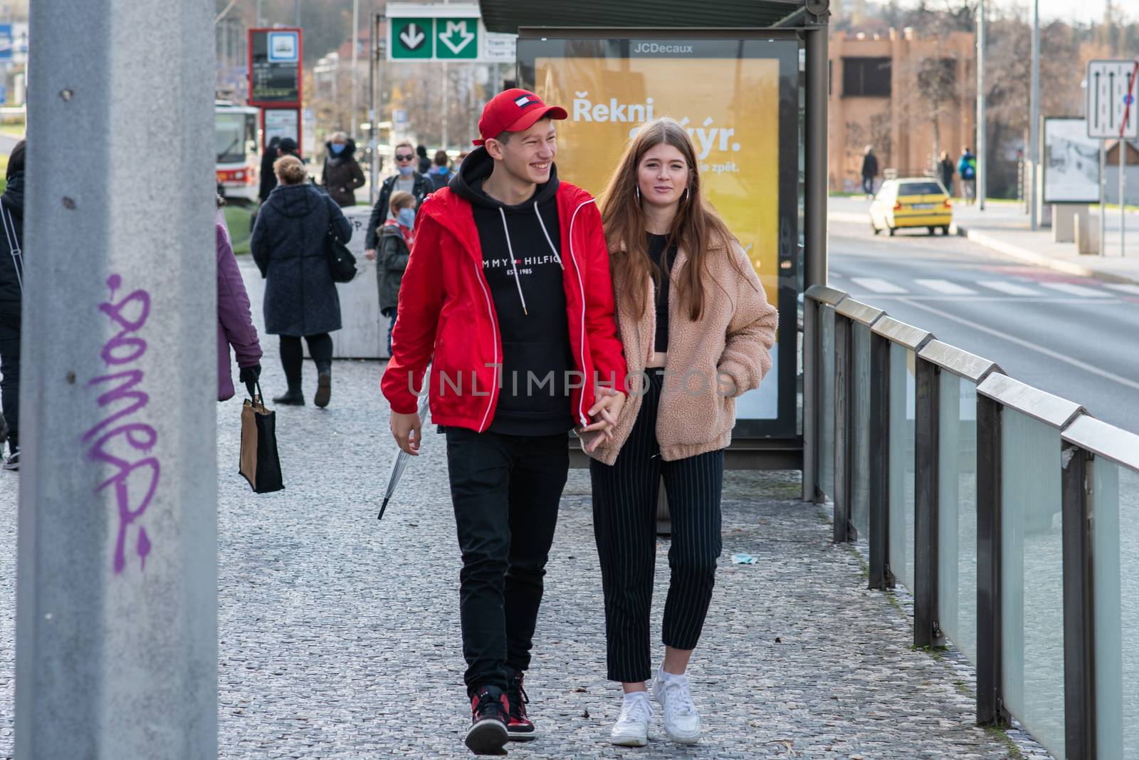 11/16/20. Czech Republic. A young couple are waiting for a tram at Hradcanska tram stop during quarantine. This is a lockdown period in the Czech Republic due to the increase of COVID-19 infectious in the country. Hradcanska tram stop it is in Prague 6