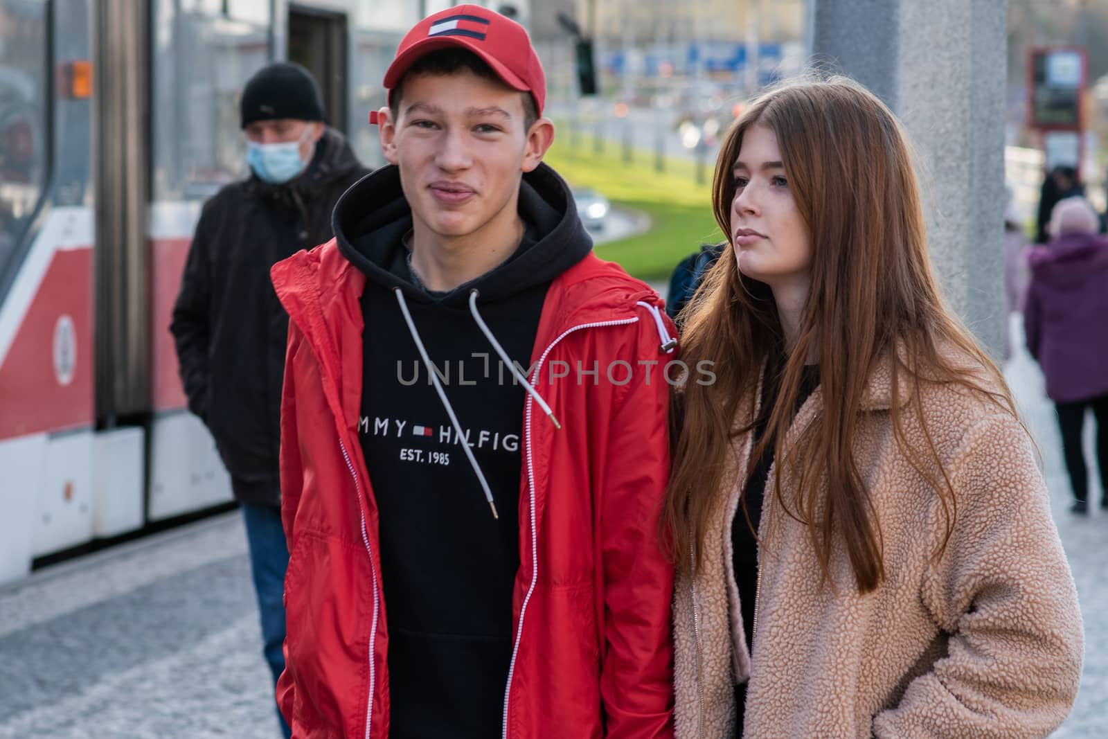 11/16/20. Czech Republic. A young couple are waiting for a tram at Hradcanska tram stop during quarantine. This is a lockdown period in the Czech Republic due to the increase of COVID-19 infectious in the country. Hradcanska tram stop it is in Prague 6