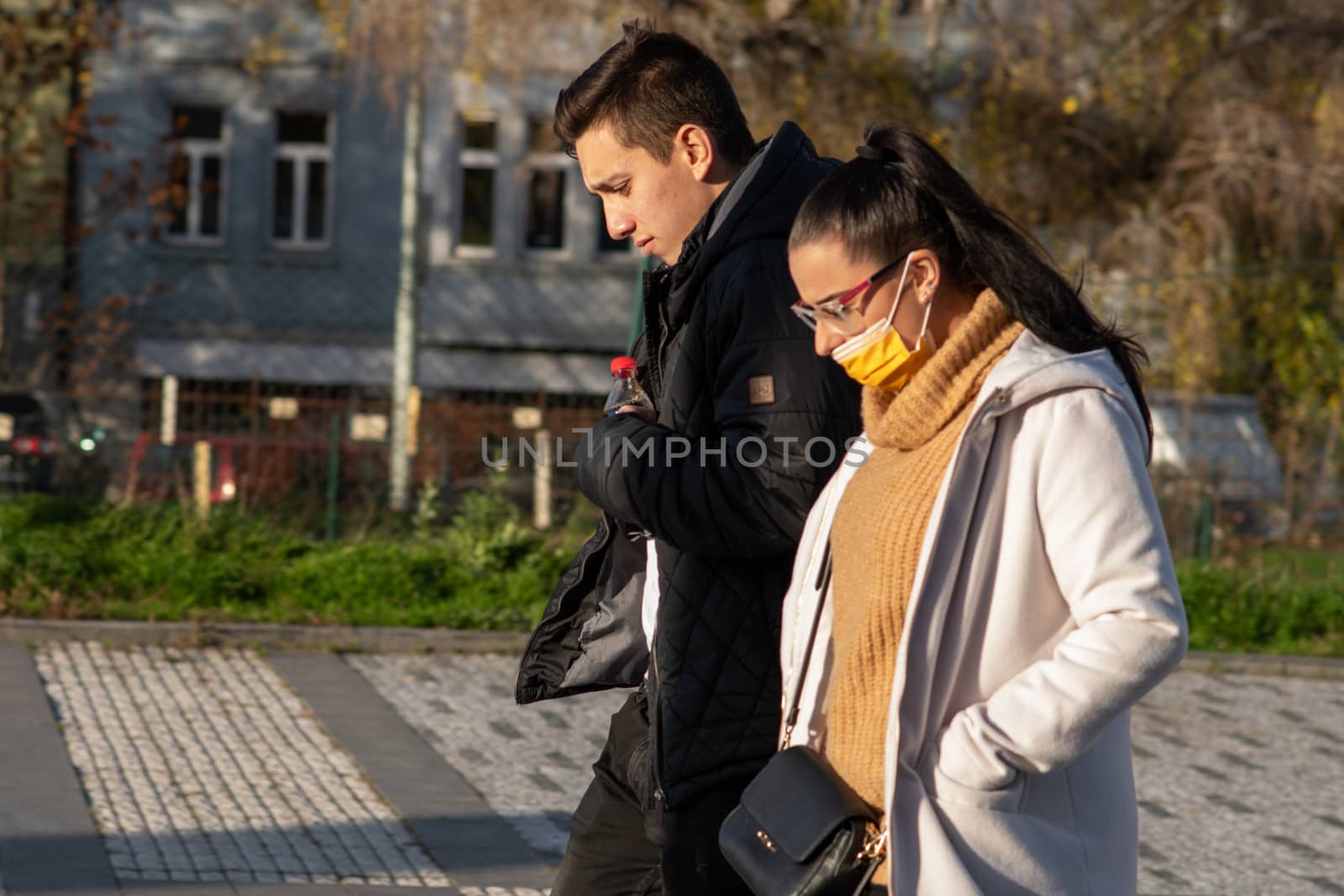 11/16/2020. Prague, Czech Republic. A couple is walking close to Hradcanska tram stop during quarantine (she is wearing a mask). by gonzalobell