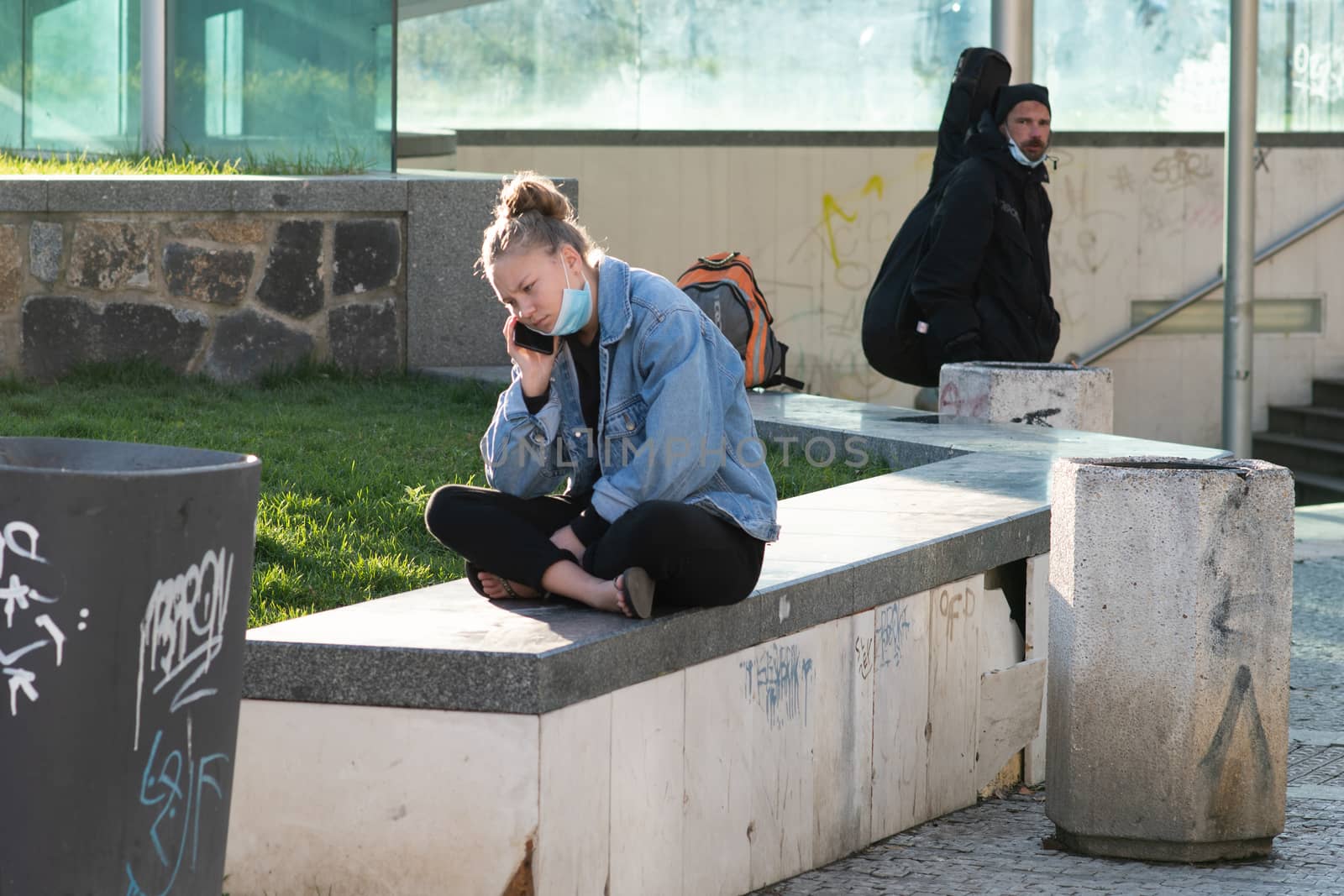 11/16/2020. Prague, Czech Republic. A young woman is talking on her phone close to Hradcanska tram stop during quarantine by gonzalobell