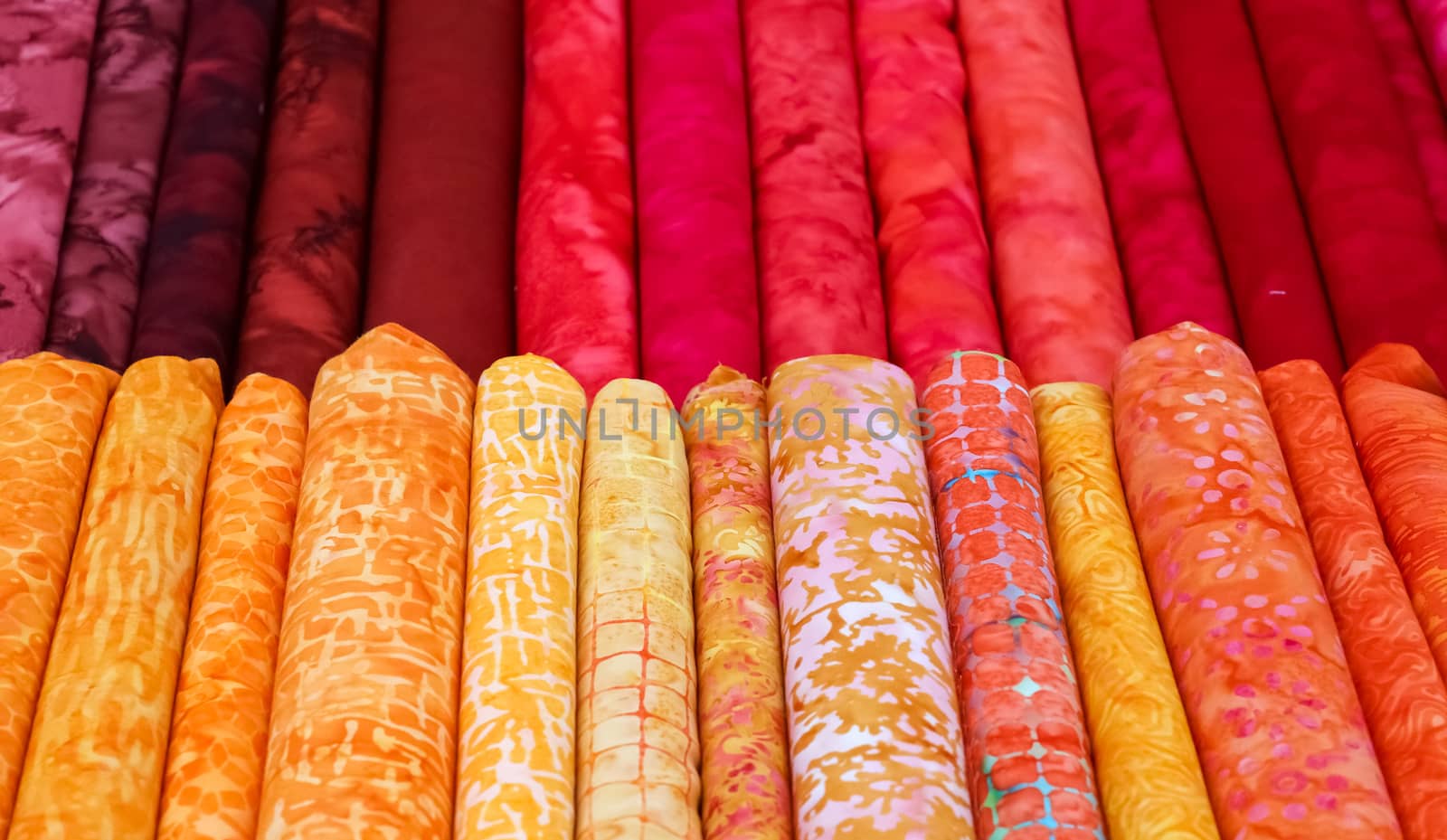 Detailed close up view on samples of cloth and fabrics in different colors found at a fabrics market.