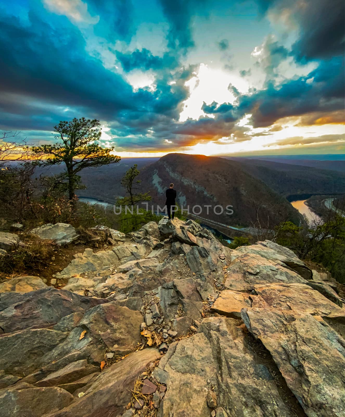 A Man Wearing All Black Standing at the Top of Mount Tammany by bju12290