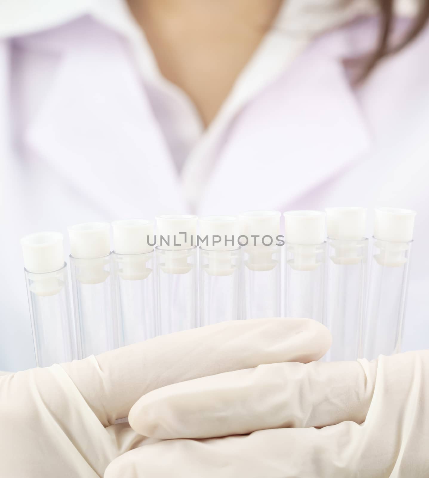 Scientist analyzing holding test tube in laboratory by stoonn