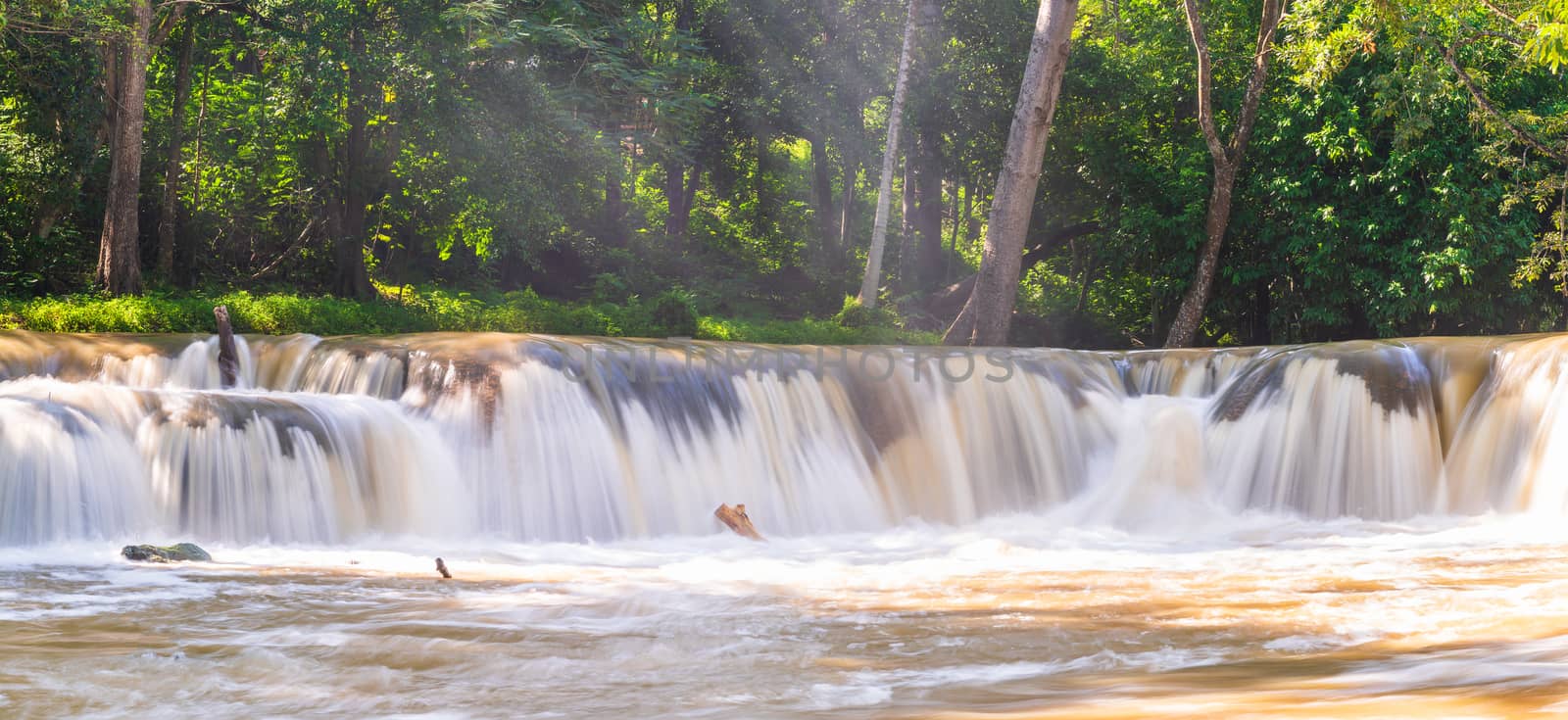 Water falls in tropical rainforest with rock and tree.  Namtok chet saonoi National Park in Thailand