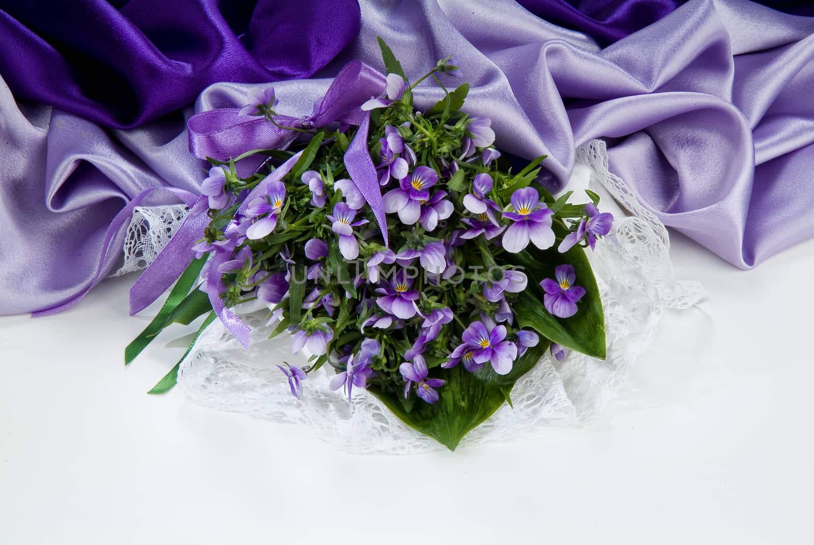 Still life with bouquet of flowers and accessories on a studio background