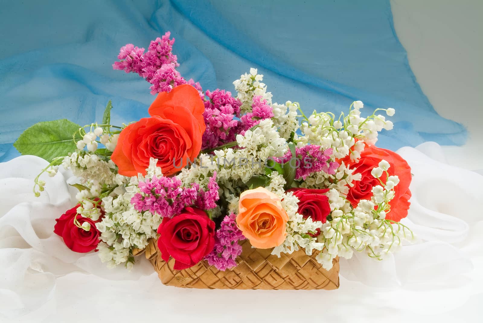 Still life with bouquet of flowers and accessories on a studio background