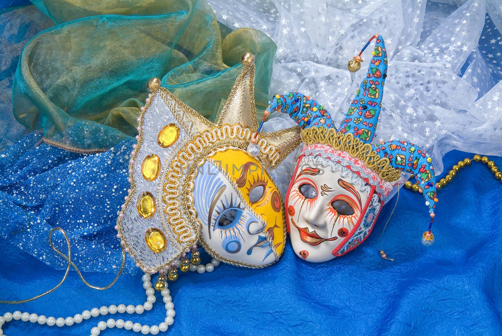 Venetian carnival masks on a fabric studio background