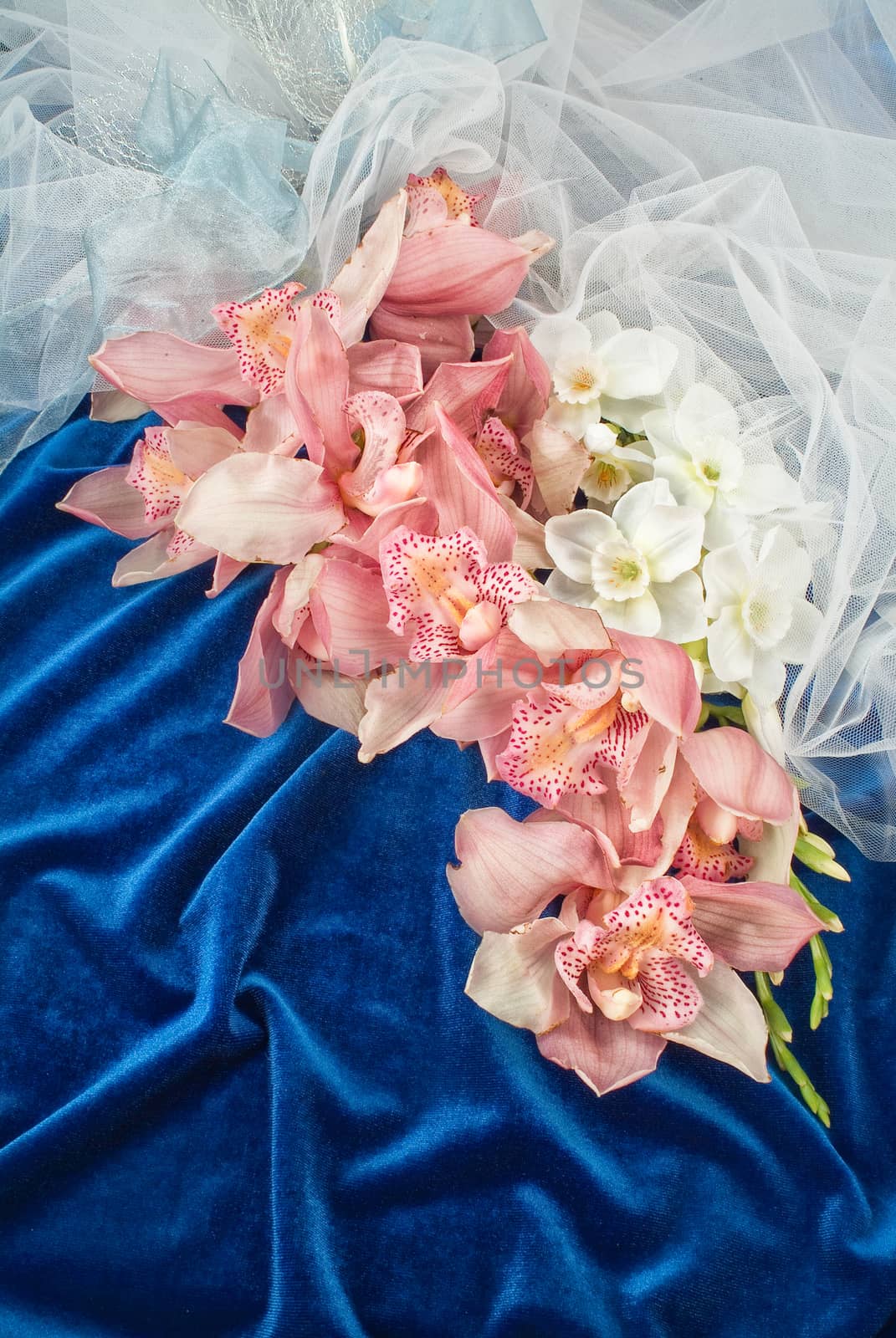 Still life with bouquet of flowers and accessories on a studio background