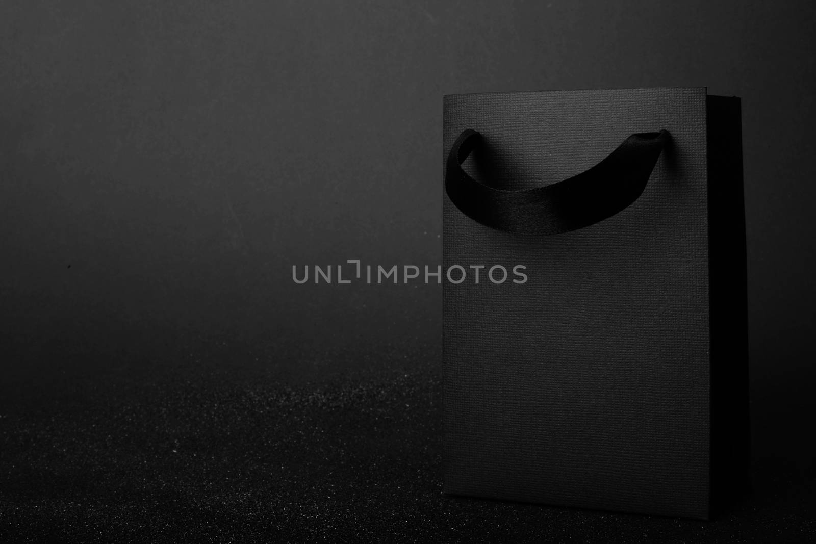 Black Friday blank empty paper bag with copy space for text and logo on dark background sale concept