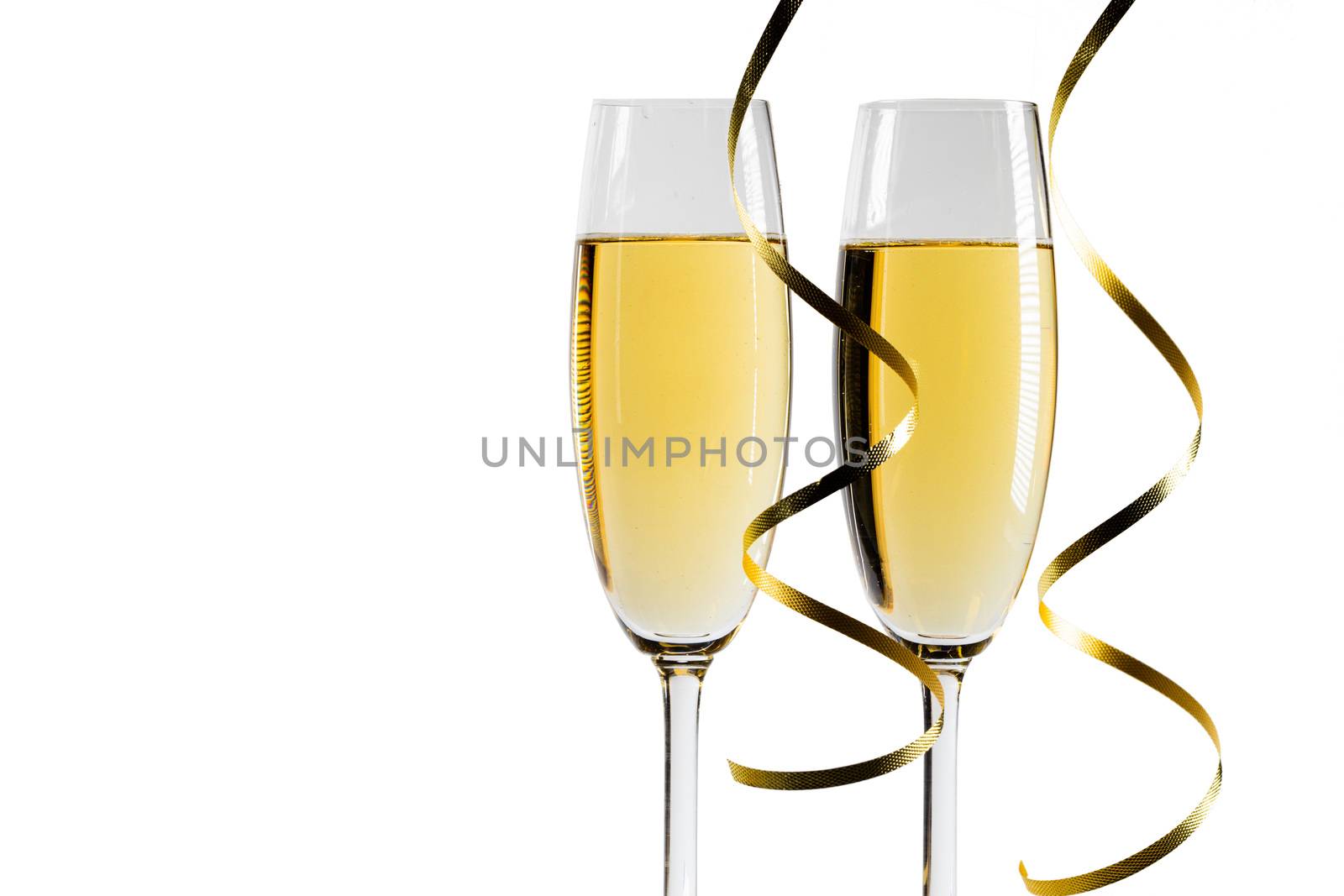 Pair glass of champagne and party curly ribbon. New year celebration or wedding concept. Studio isolated on white background
