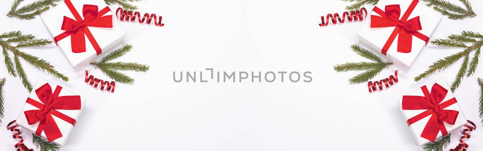 Christmas composition of green fir tree branch and Xmas gifts isolated on white background. Top view, flat lay. Copy space for text