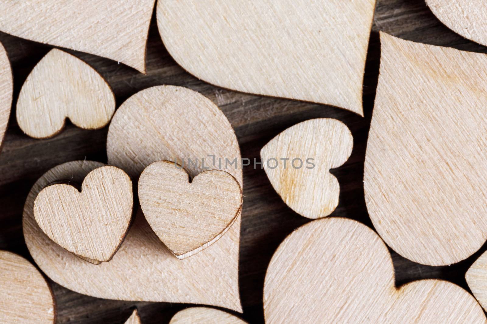 Many wooden colorless hearts background, two special ones true love concept