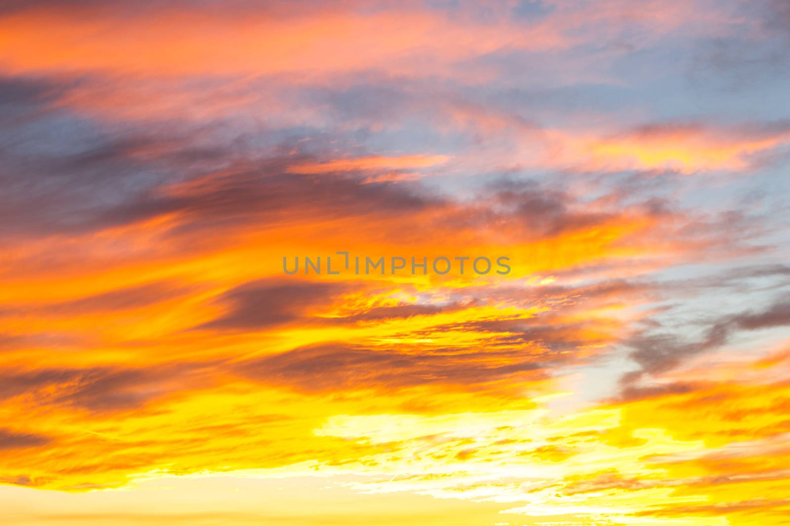 Dramatic yellow and orange colored sunset cloudscape for background or sky replacement photo editing by kb79