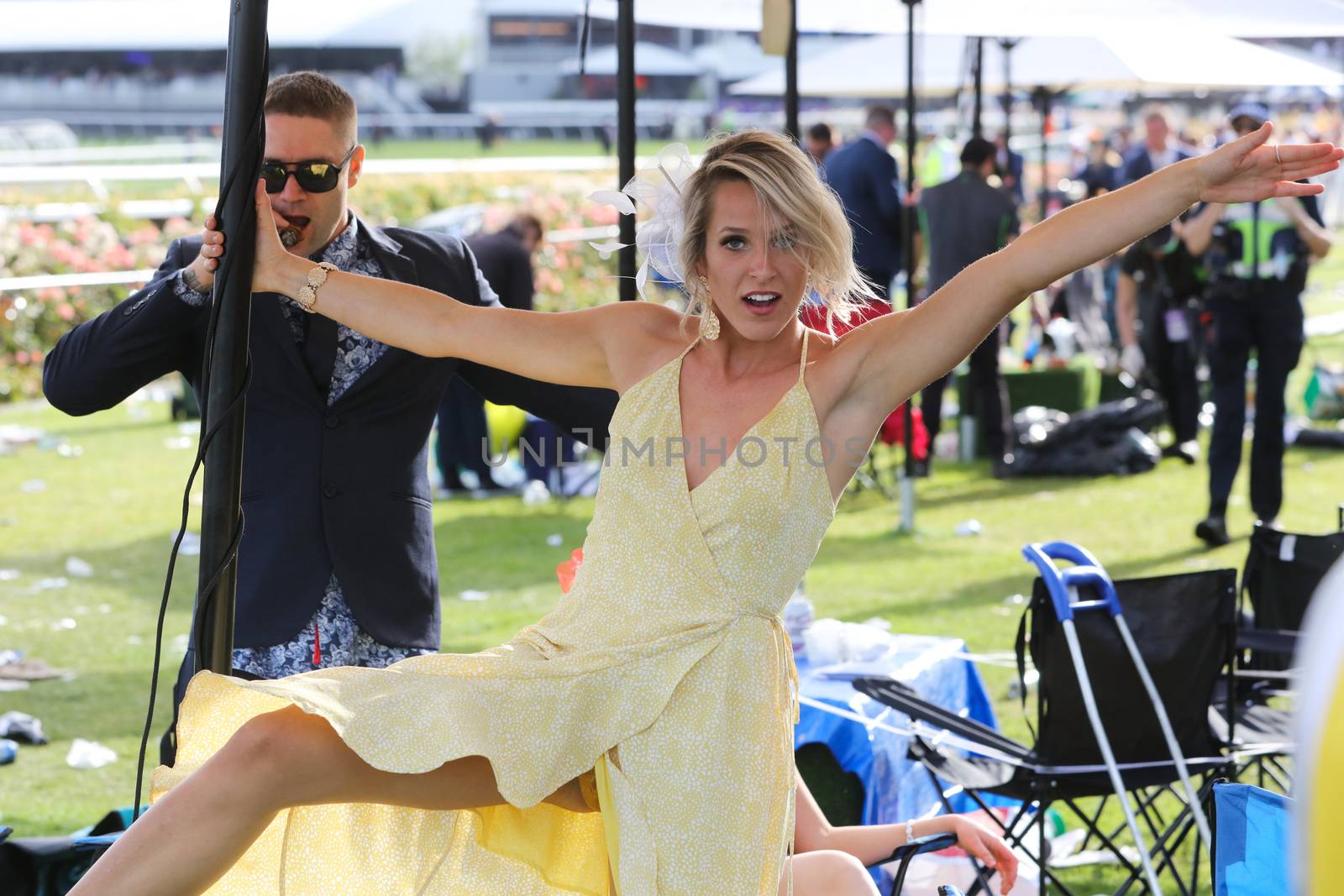 MELBOURNE, AUSTRALIA - NOVEMBER 05, 2019: Drunnk punters at the end of the Lexus Melbourne Cup Day at the 2019 Melbourne Cup Carnival at Flemington Racecourse in Melbourne Australia