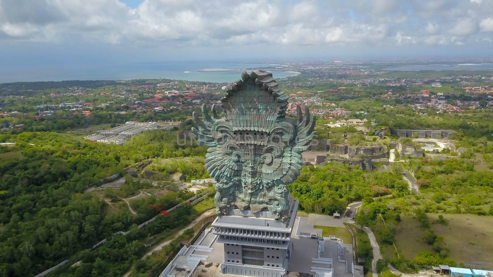 Landscape picture of tallest Garuda Wisnu Kencana GWK statue as Bali landmark with blue sky as a background. Balinese traditional symbol of hindu religion. Popular travel destinations in Indonesia.