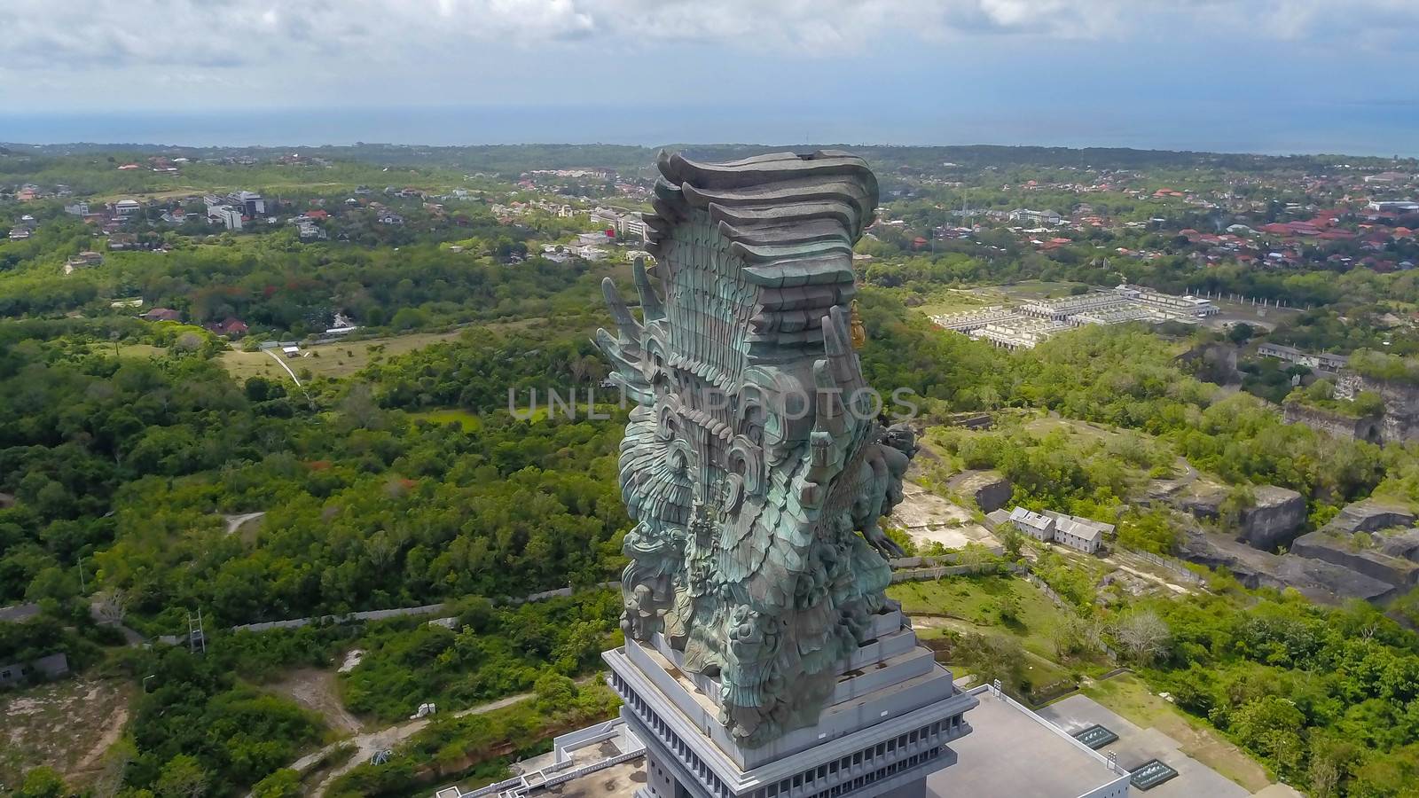 Landscape picture of tallest Garuda Wisnu Kencana GWK statue as Bali landmark with blue sky as a background. Balinese traditional symbol of hindu religion. Popular travel destinations in Indonesia by Sanatana2008