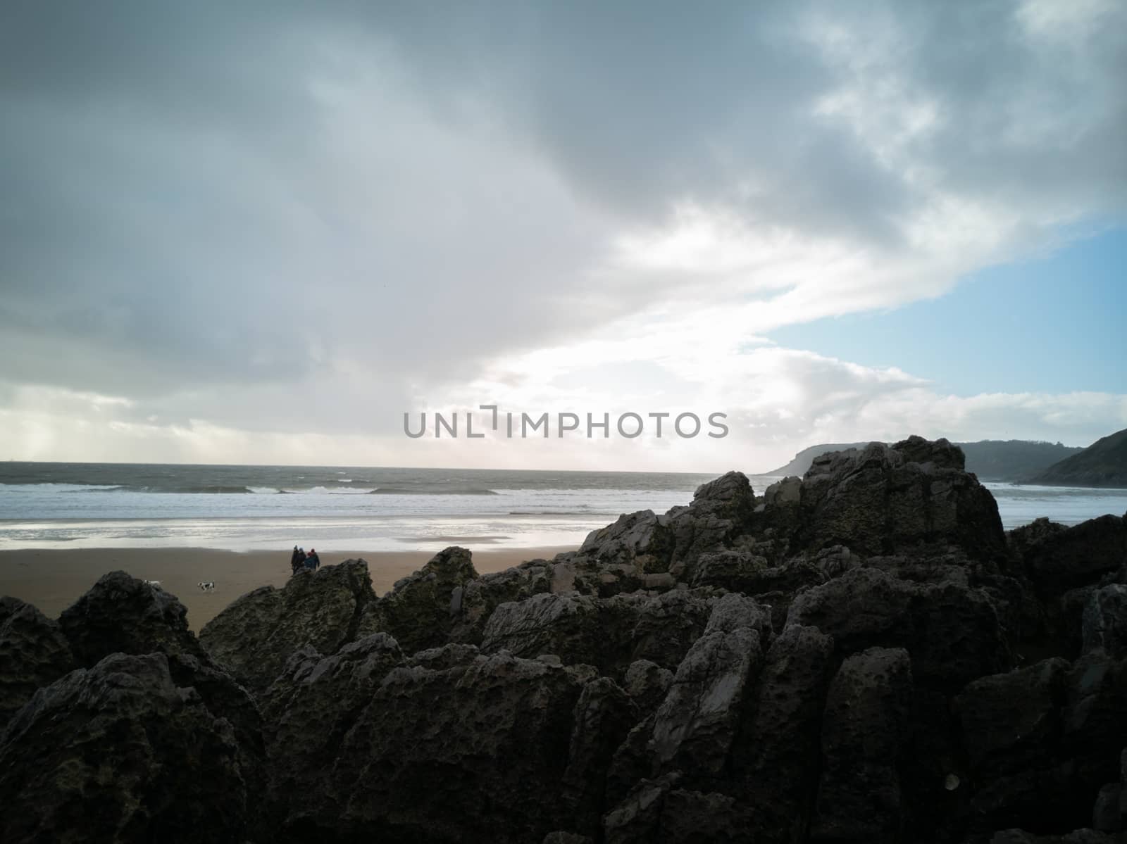 Overlooking the ocean from the rocks on a cloudy day at Caswell Bay Beach towards winter. by WCLUK