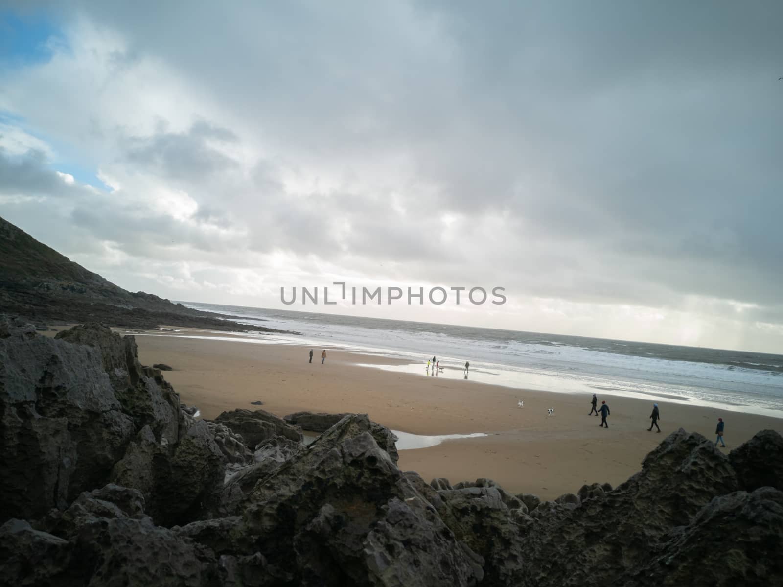 Looking down on Caswell Beach from the rock formations to the rear of the Bay on a cloudy and Autumns day. by WCLUK