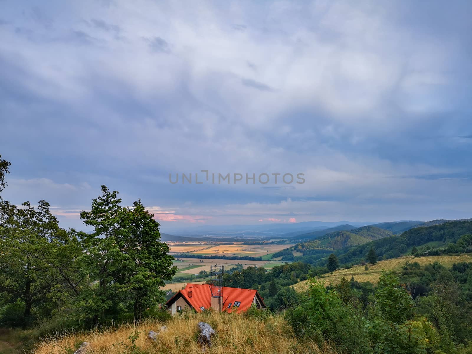 Cloudy afternoon at mountains with red roof building by Wierzchu