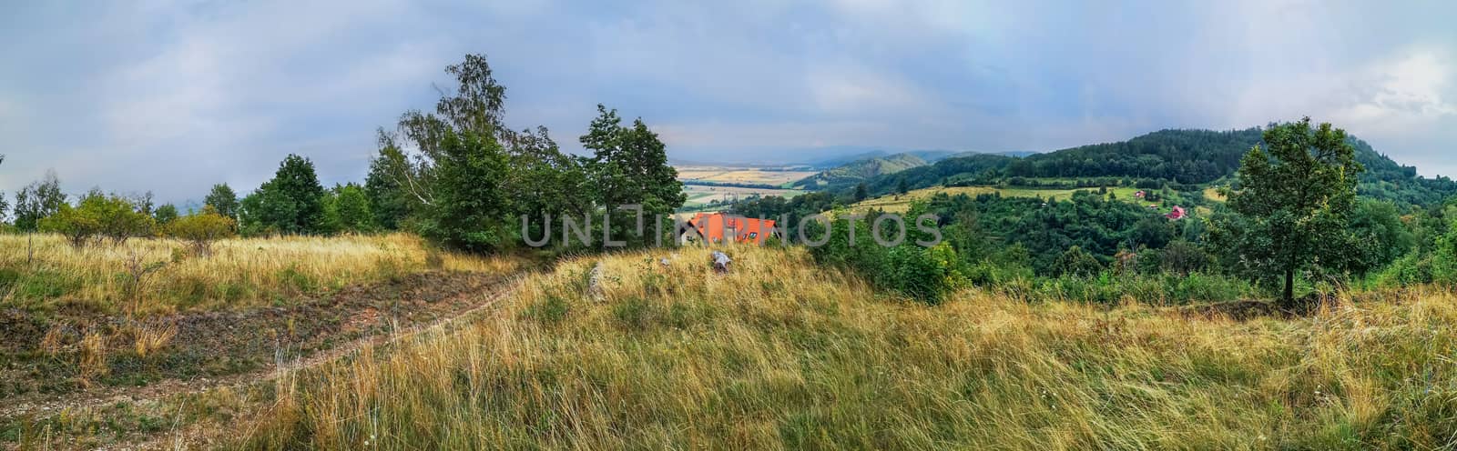 Panorama of cloudy afternoon at mountains with red roof building by Wierzchu