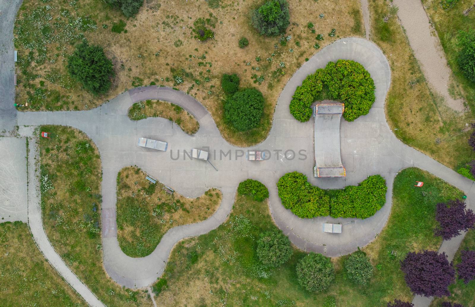 Top down aerial look to skatepark ramps near house development by Wierzchu