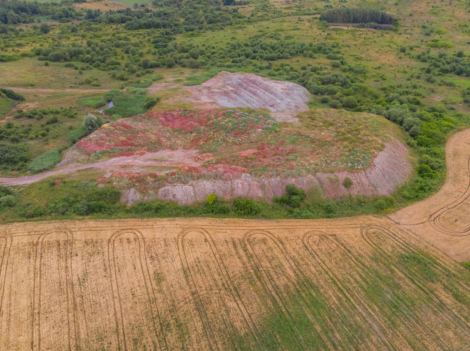 Aerial look to hill near fields and bushes