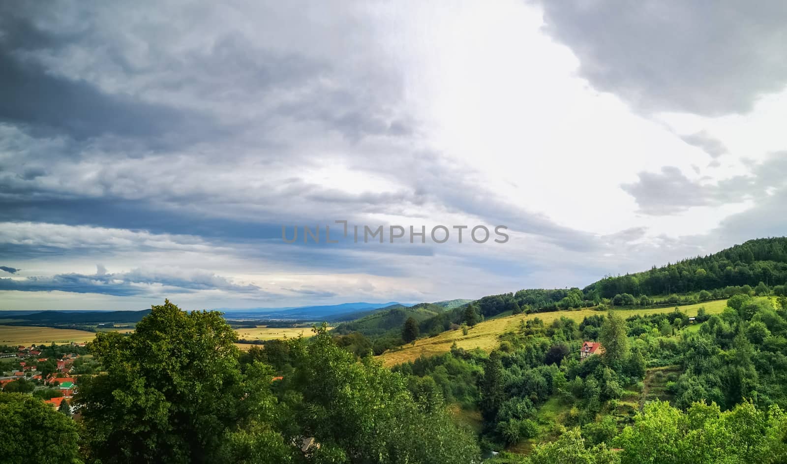 Look to small village in mountains and fields