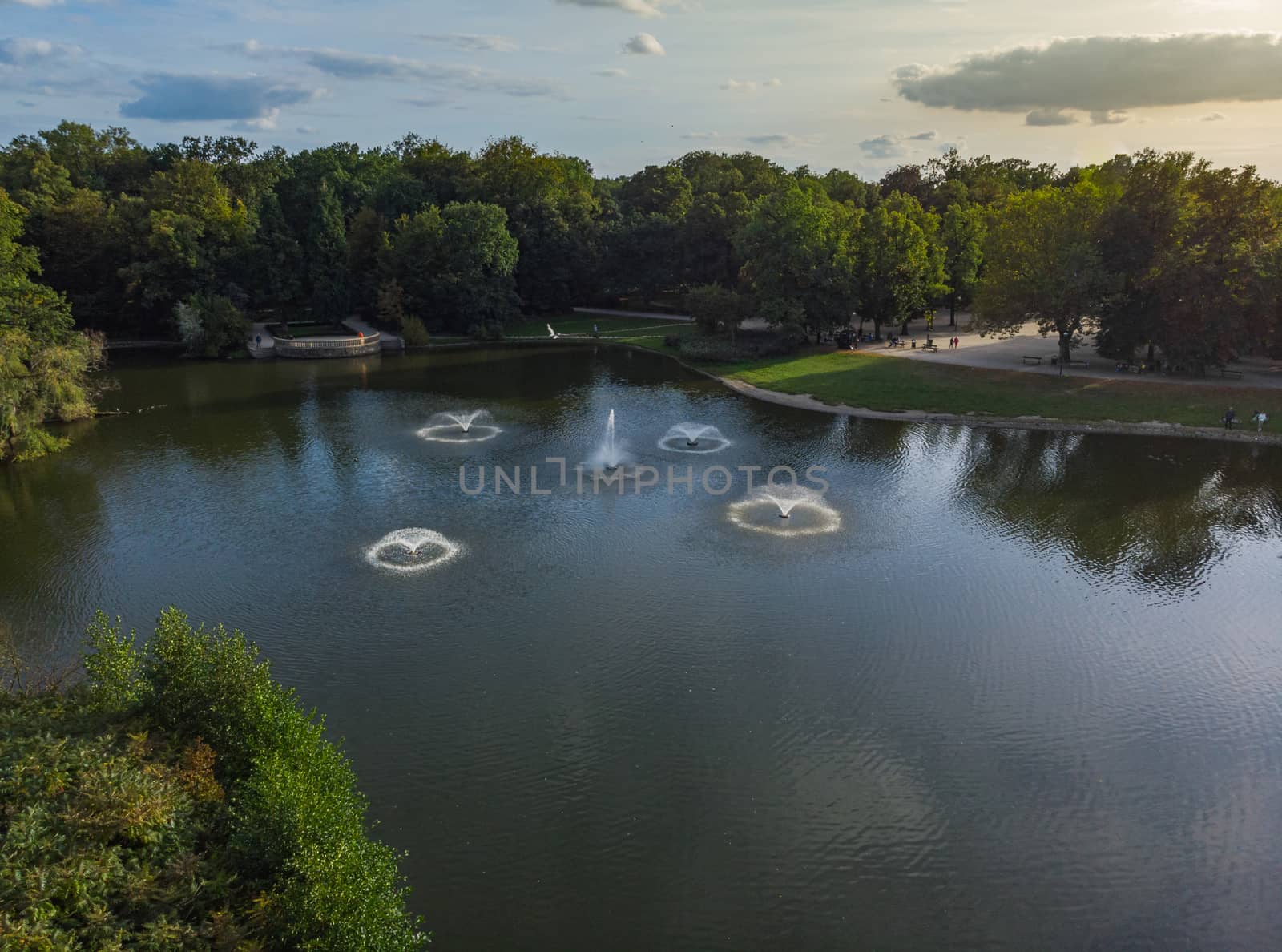 Aerial view to small fountains at center of lake in Wroclaw south park by Wierzchu