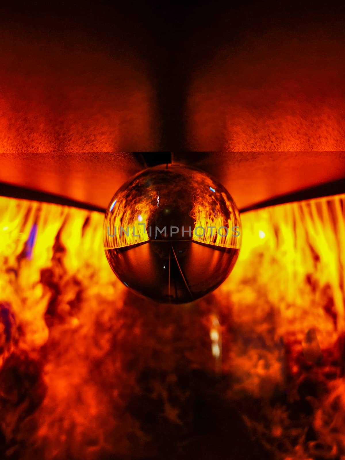 Glassy crystal lensball between paths with fake fire