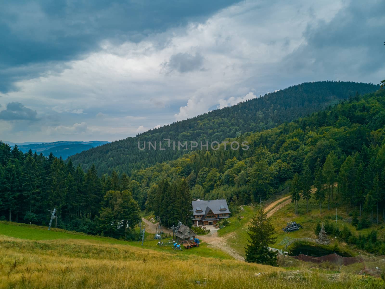 Small Wooden shelter in Owl Mountains between bushes and forest