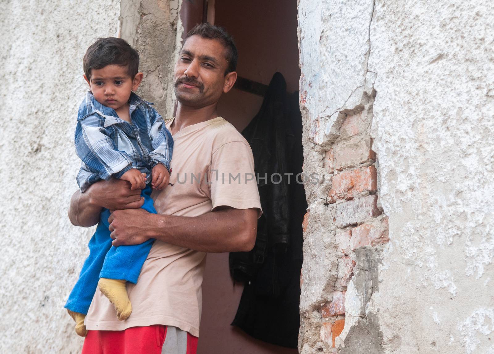 5/16/2018. Lomnicka, Slovakia. Roma community in the heart of Slovakia, living in horrible conditions. Portrait of father and baby. by gonzalobell