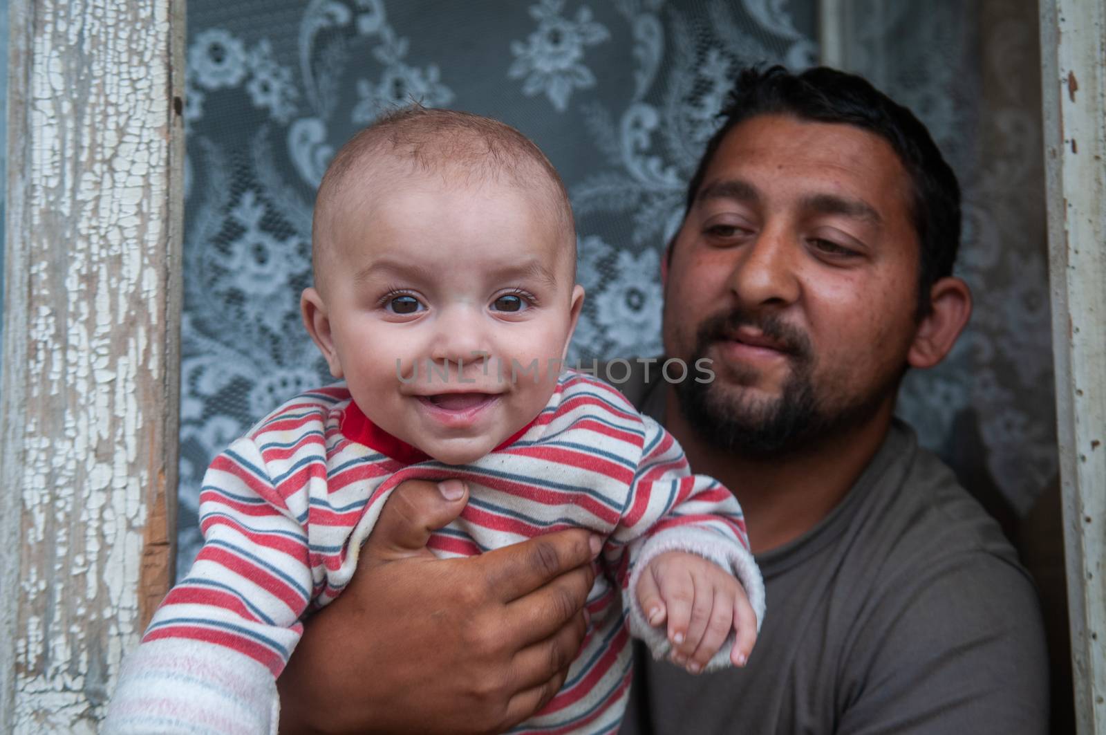 5/16/2018. Lomnicka, Slovakia. Roma community in the heart of Slovakia, living in horrible conditions. Portrait of father and baby. by gonzalobell