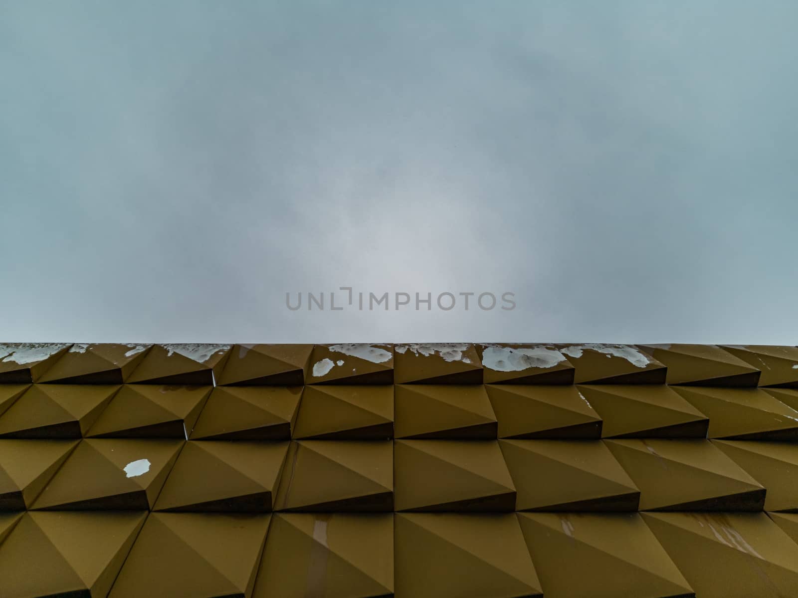 Upward view to facade of shop roof with peeling painting by Wierzchu