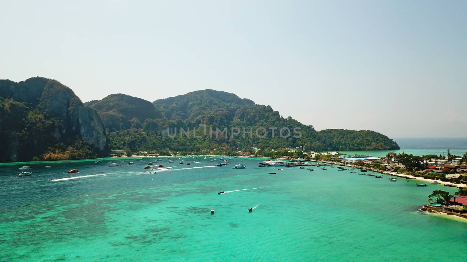 Turquoise clear water. Yachts, boats floating. by Passcal