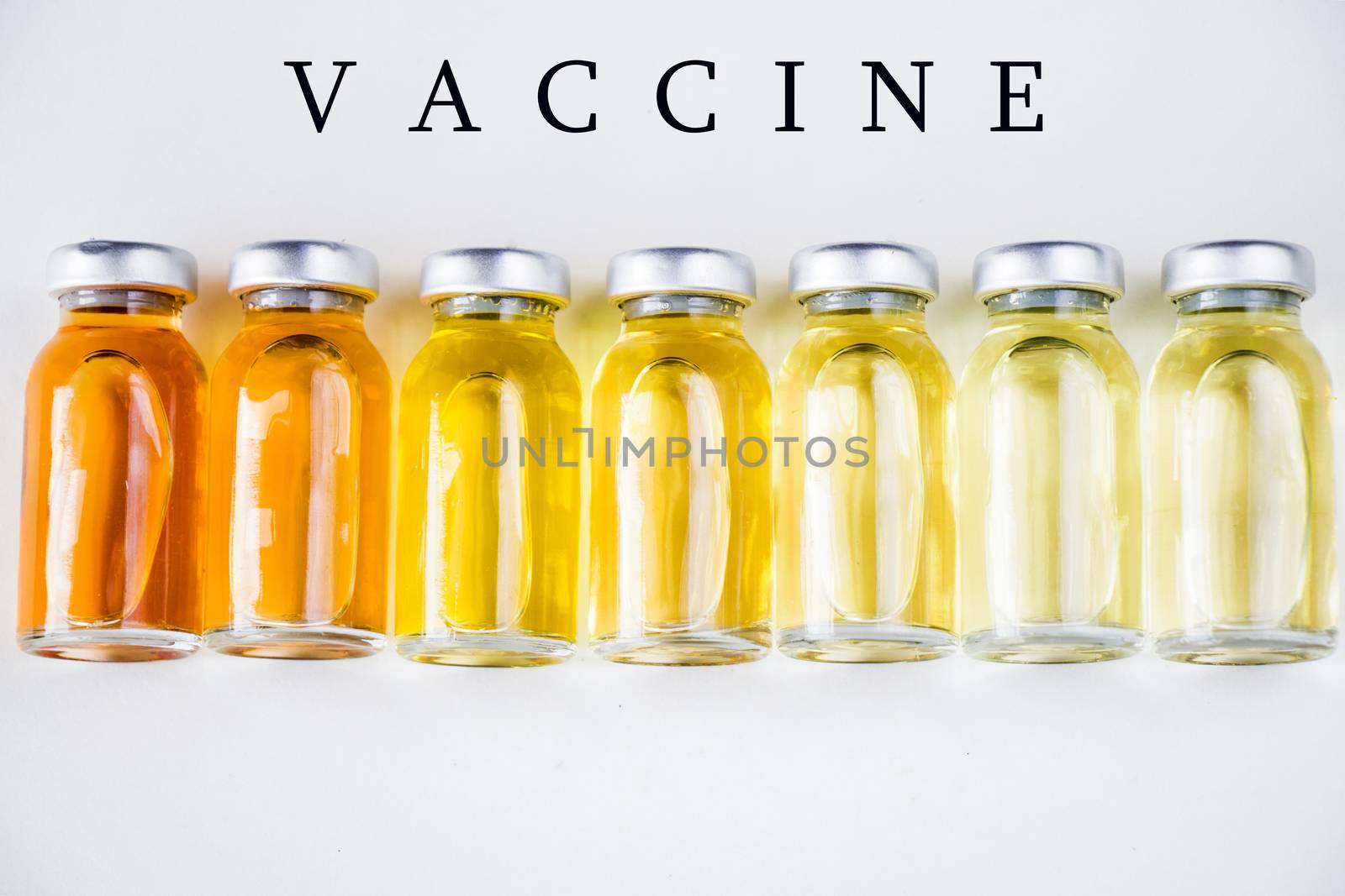 New vaccine in ampules, different color variations of vaccine on the white background, bottle and liquid drug, Corona virus