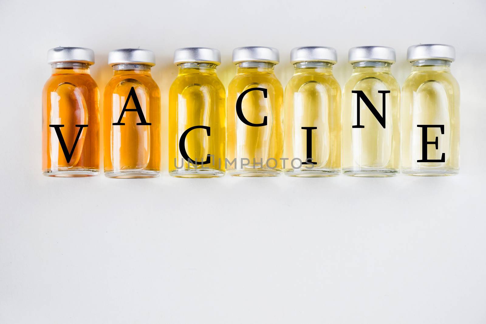 New vaccine in ampules, different color variations of vaccine on the white background, bottle and liquid drug, Corona virus