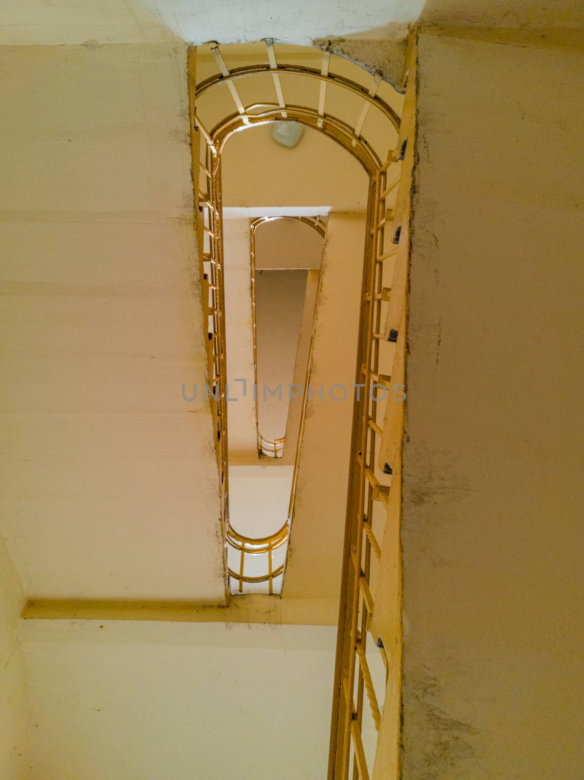 Upward view to spiral staircase with yellow railing