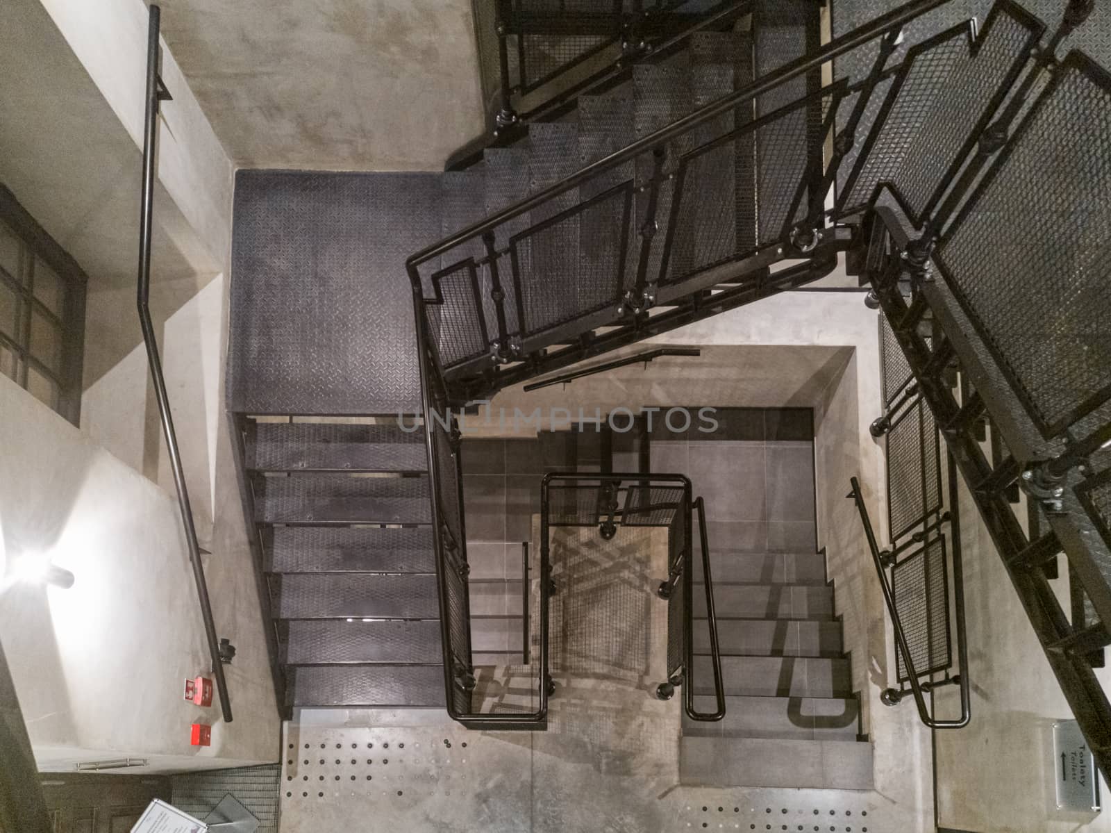 Top down view to metal stairs and concrete walls by Wierzchu