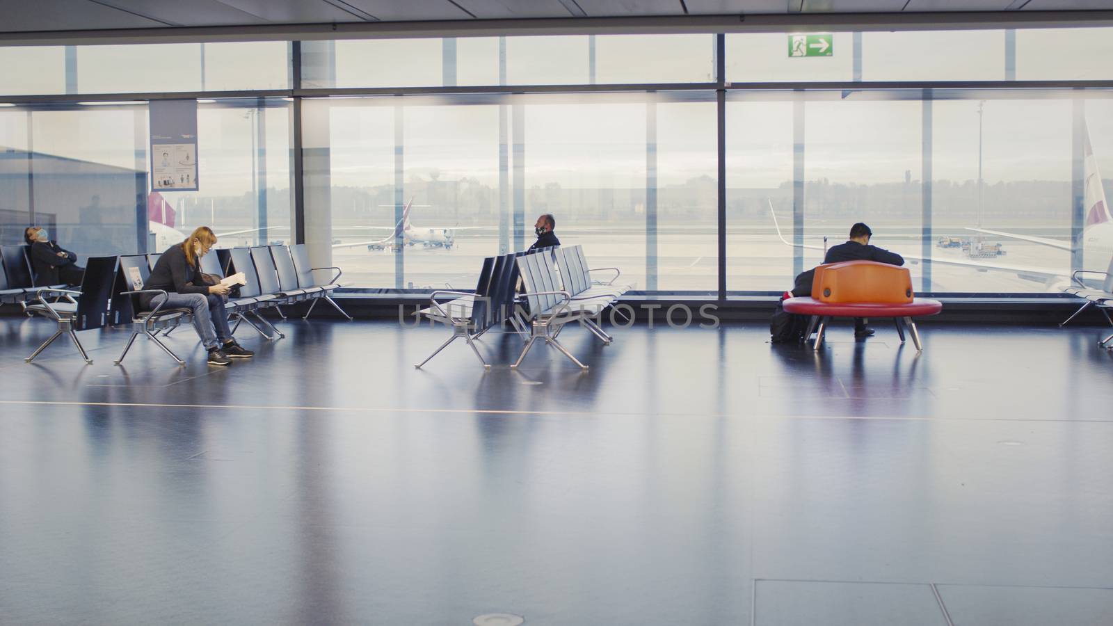 Vienna, Vienna/Austria - November 2nd 2020: Passengers waiting at Vienna airport. Only a few people travelling and a lot of closed gates.