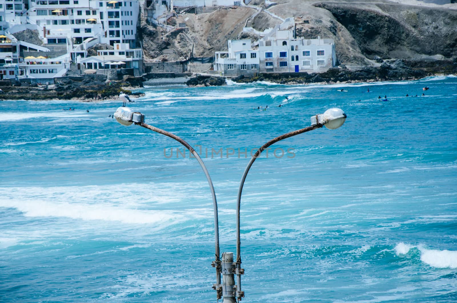 Lamp post on the beach, rusty by the sea breeze