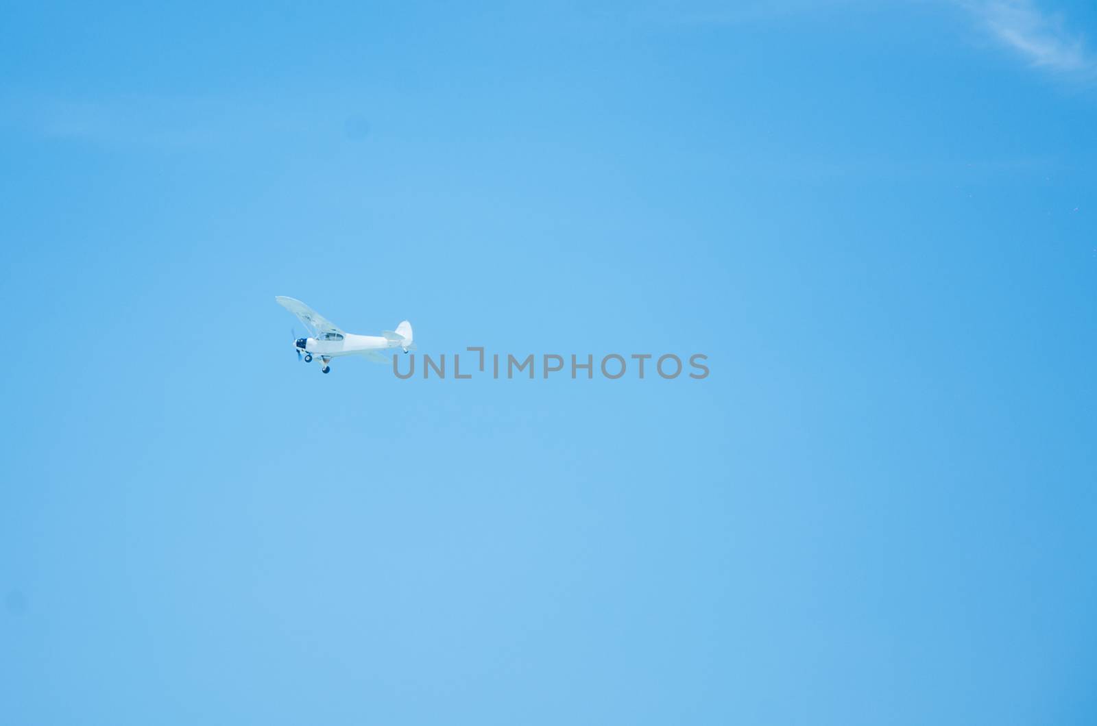 A small plane sailing through the blue skies
