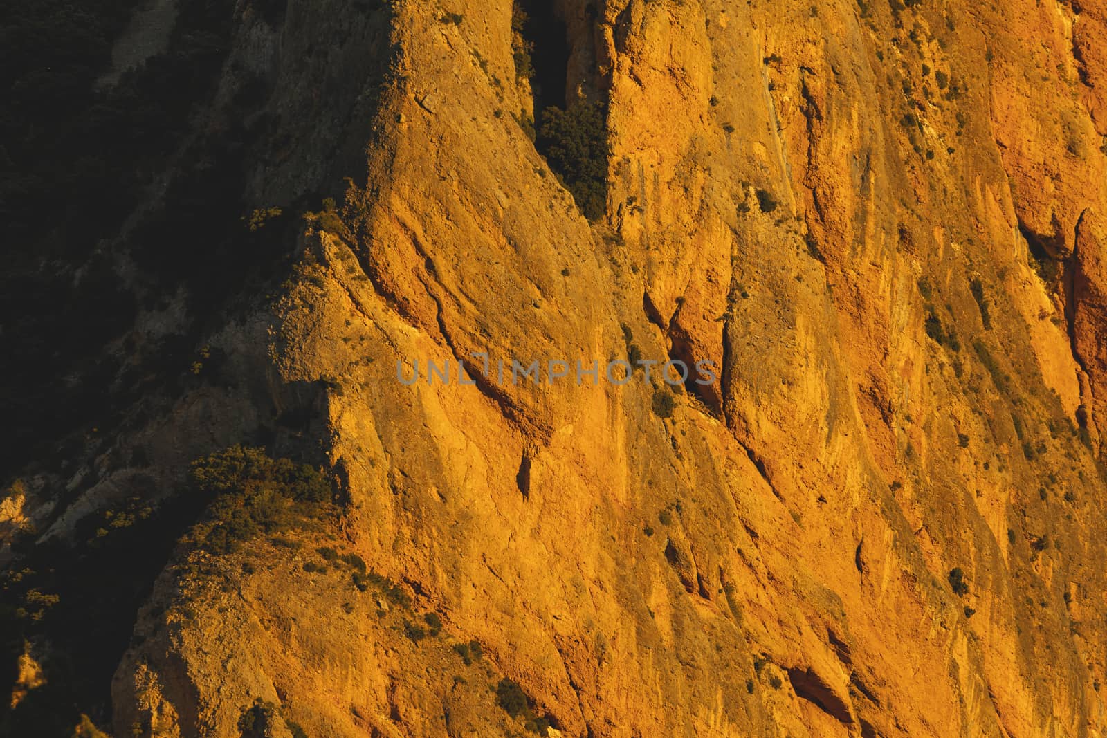 Mountains of the Mallos de Riglos, vertical rock walls at sunset, a famous place for climbing near the Gallego river, in the pre-Pyrenees, Huesca province, Aragon, Spain.