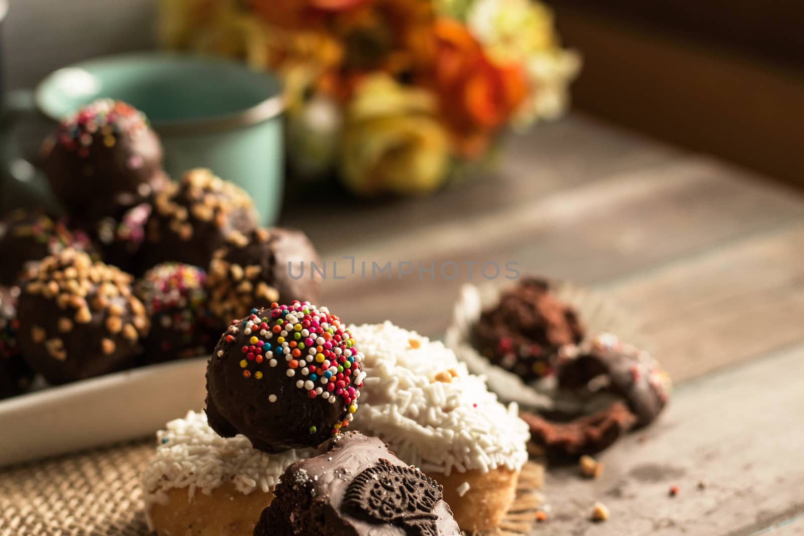 Colorful chocolate and donuts on a plate in a restaurant.