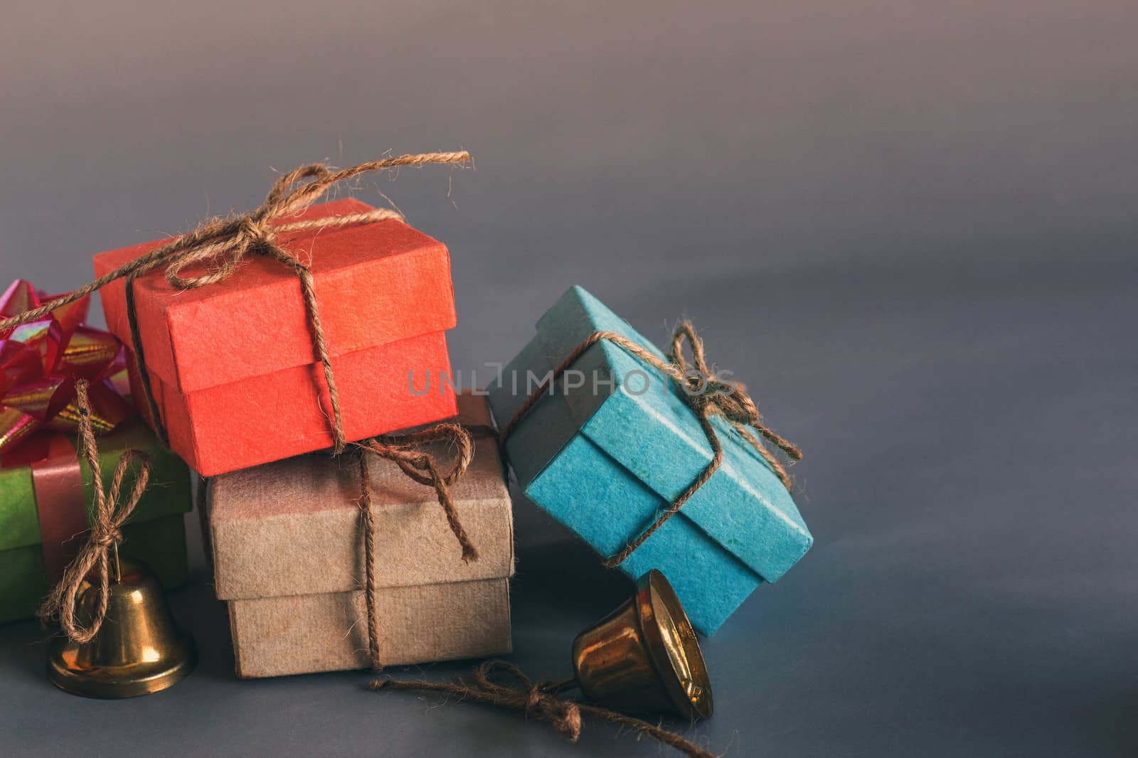 Gift box with bells on a gray background.