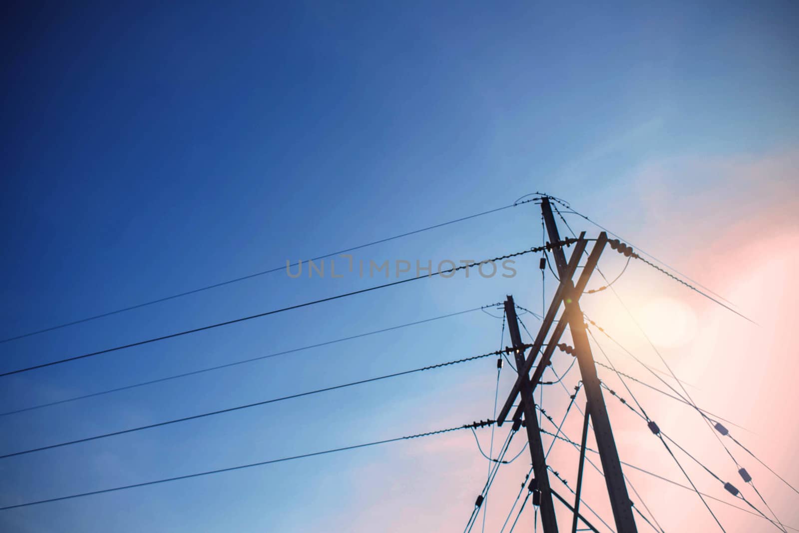 Electric pole with sunlight during the day.