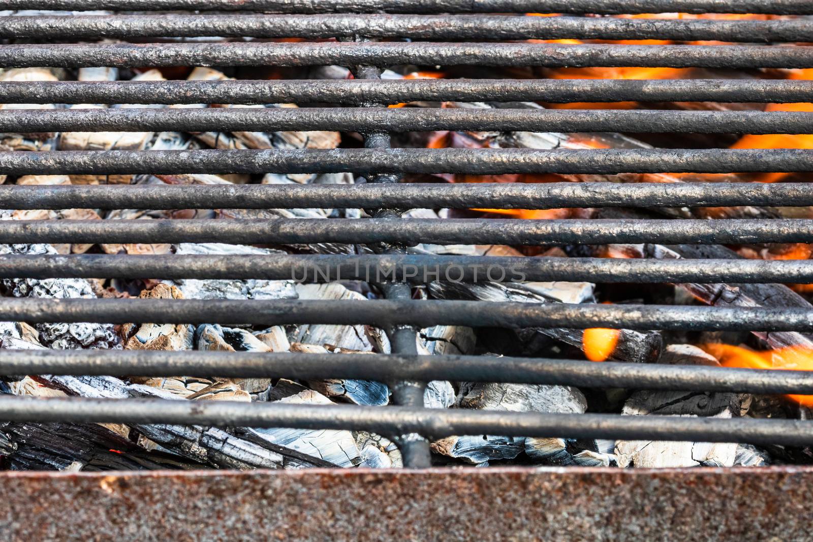 Empty hot charcoal barbecue BBQ grill with burning fire with flame and smoke. Hot coal made of greatly heated wood