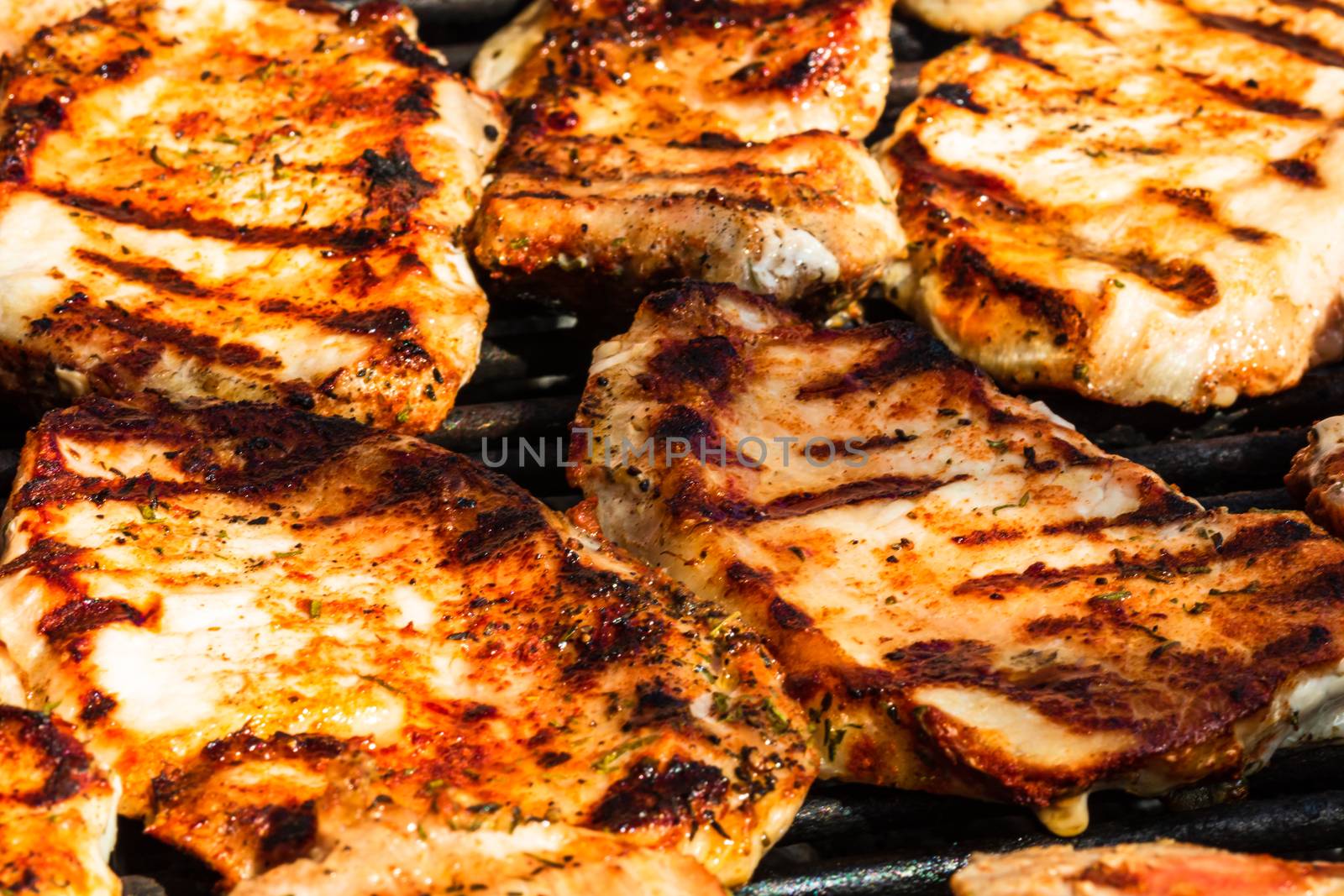 Grilling pork steaks. Delicious meat steaks close up cooking on the barbecue grill