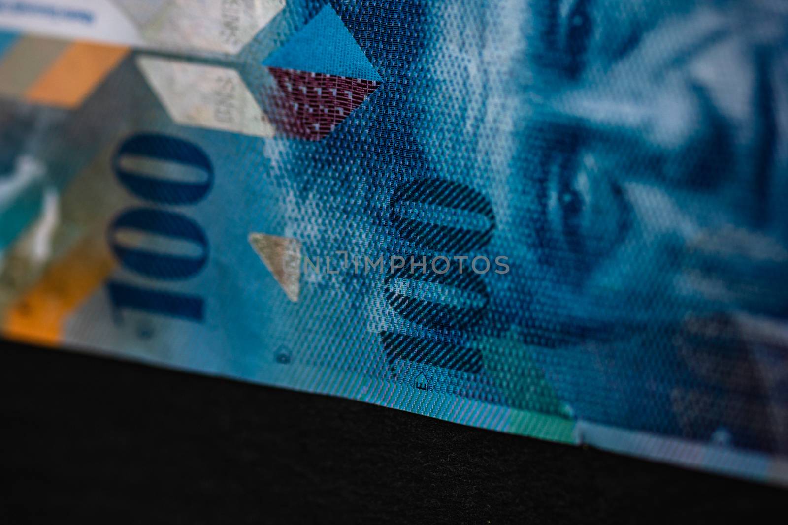 Selective focus on detail of 100 swiss franc banknote. Close up  by vladispas