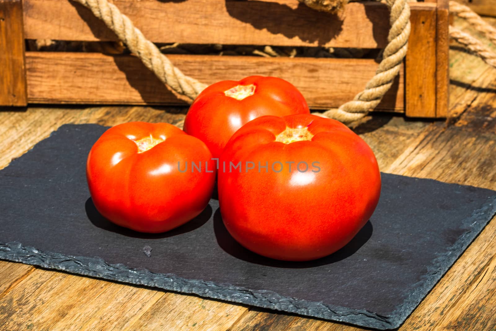 Close up of fresh ripe tomatoes isolated in a rustic composition,