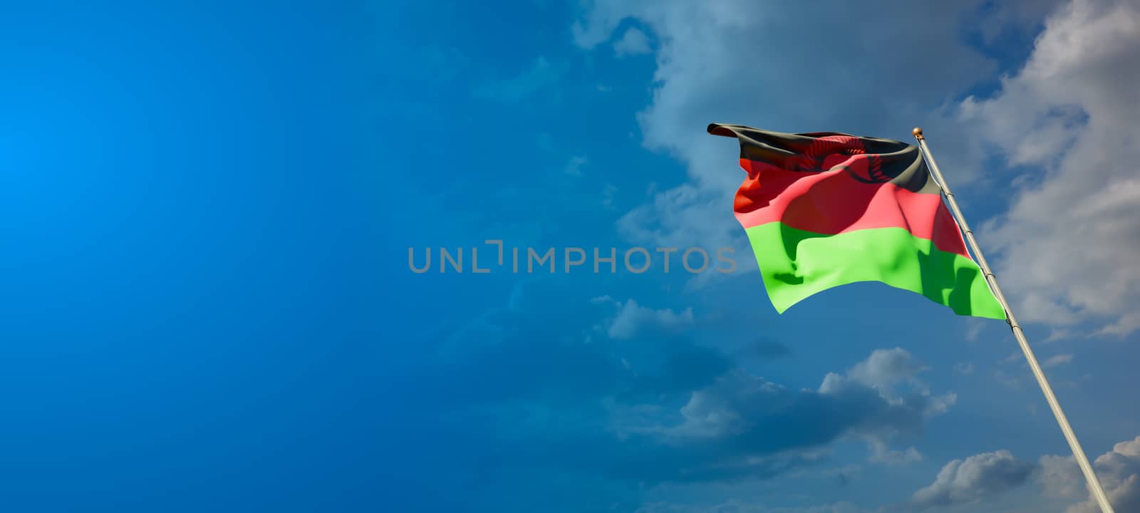 Malawi national flag with blank text space on wide background. by altman